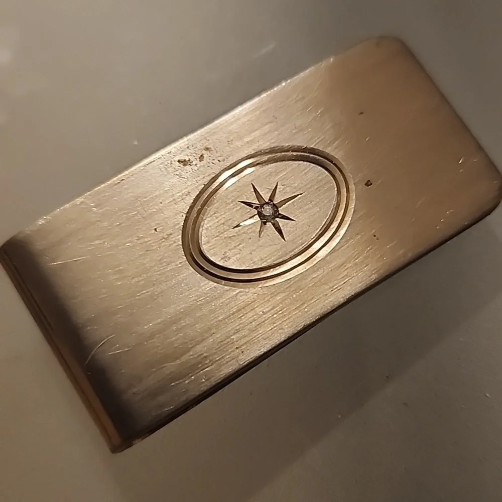 Goldtone  Money Clip With A Diamond Like Stone.